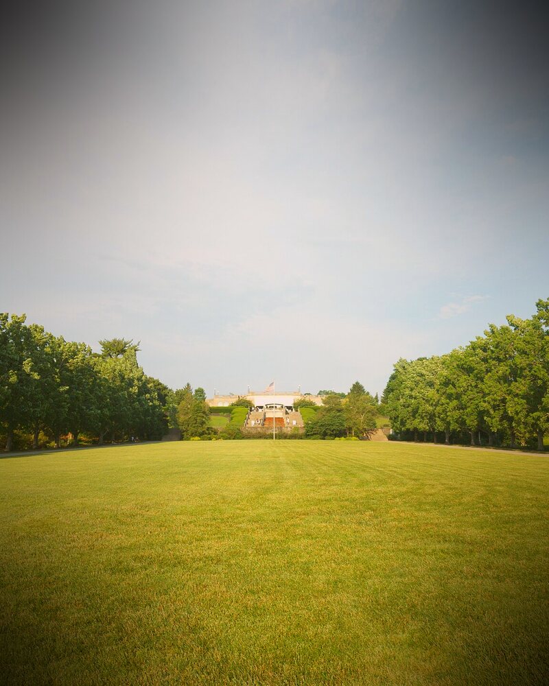 Ault Park's long lawn lined with trees, leading up to the pavilion